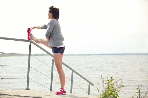 Female Runner Stretching Her Legs