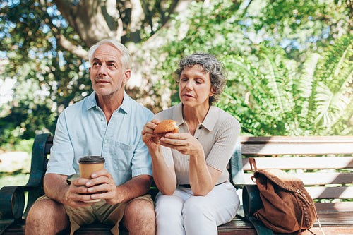 Senior couple sitting outdoors on a park