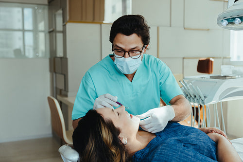 Dentist examining patient during dental checkup in a modern clinic