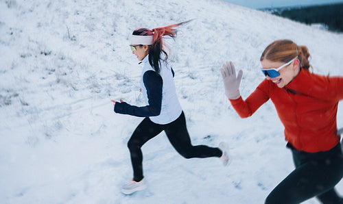 Her running pace with women in winter snow reflects teamwork and strength