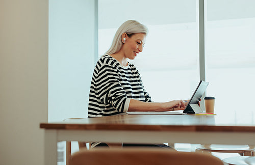 Female digital creator working on tablet