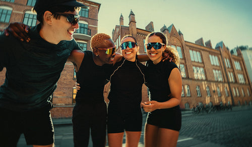 Socializing after a group run, the friends linger outdoors in the city together