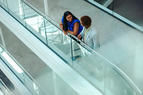 Colleagues discussing projects in a modern office stairway