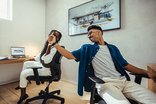 Young architects brainstorming ideas together while working in a creative office environment