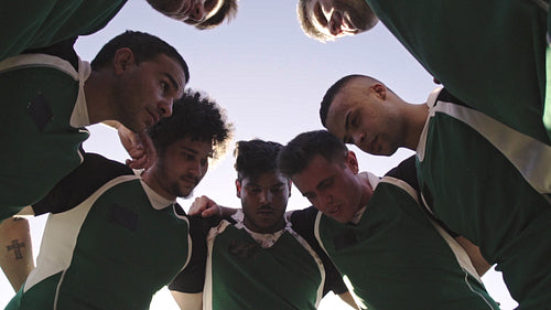 Rugby players huddling