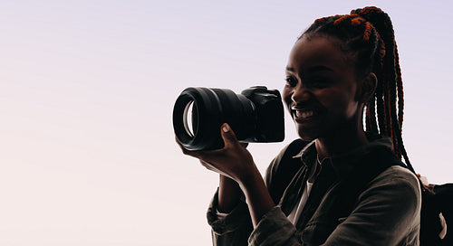 Adventure lifestyle: Confident photographer capturing memories with digital camera