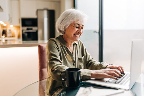 Cheerful senior businesswoman working in her home office