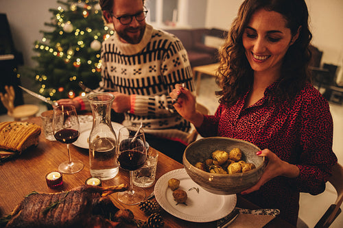 Couple enjoying Christmas dinner at home