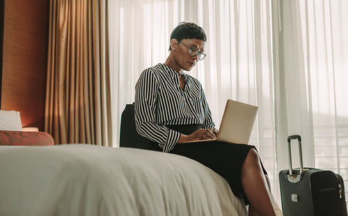 Woman doing business from hotel room