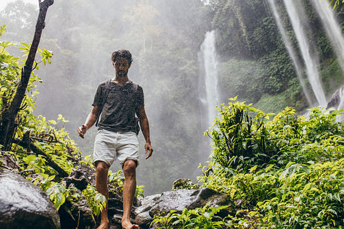Male hiker walking down the mountain trail