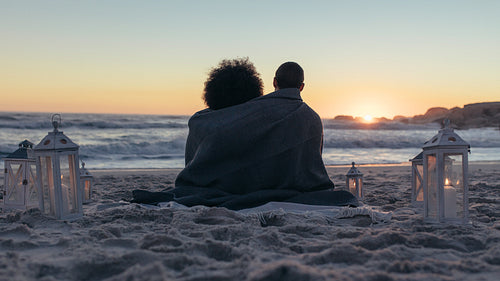 Couple admiring the sunset from beach