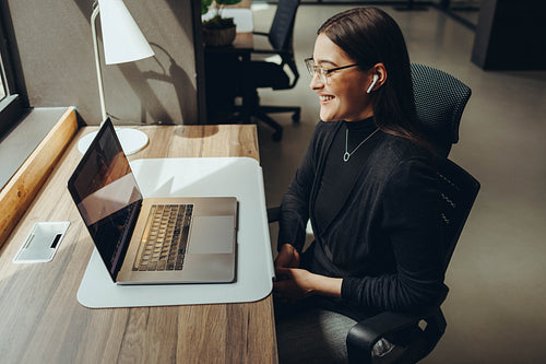Young businesswoman having a virtual meeting in a coworking offi
