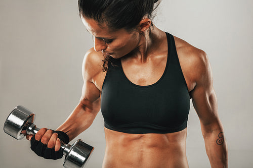 Strong healthy young women lifting weights