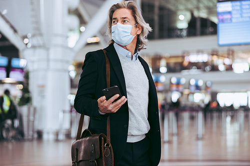 Transit passenger with face mask at airport