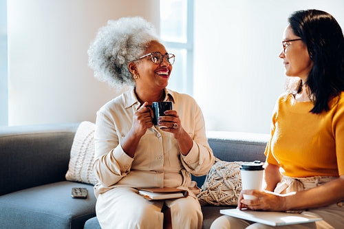 Colleague connection: Senior woman enjoys a warm break conversation