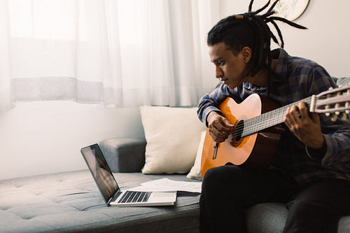 African American musician taking an online music lessons