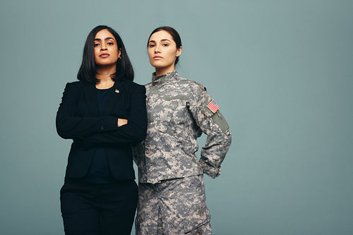 Congresswoman and servicewoman standing in a studio