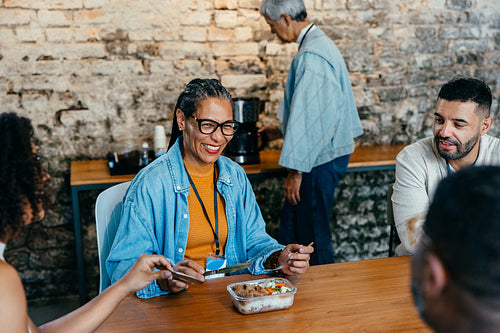 Diverse group of coworkers enjoying a meal together