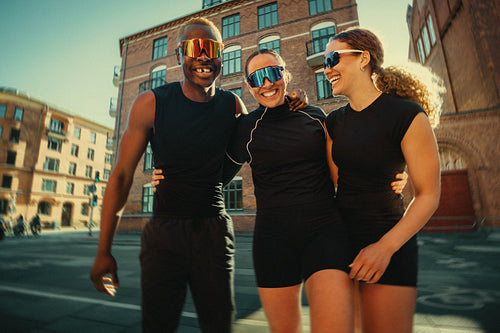 The running friends enjoy a workout walk together in an urban club setting