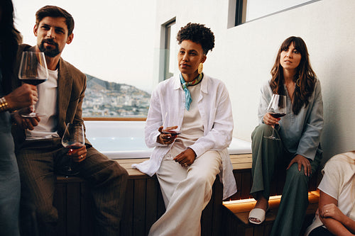 Group of friends enjoying a casual evening on an outdoor terrace