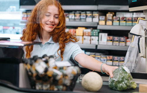 Cashier scanning products at a grocery store