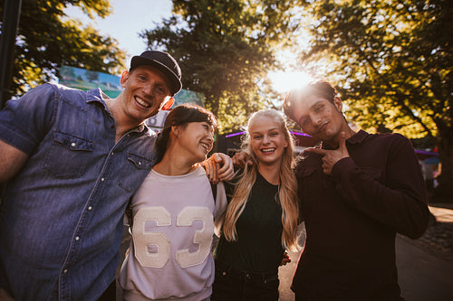 Happy young friends walking in amusement park