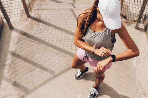 Female runner looking at smart watch heart rate monitor