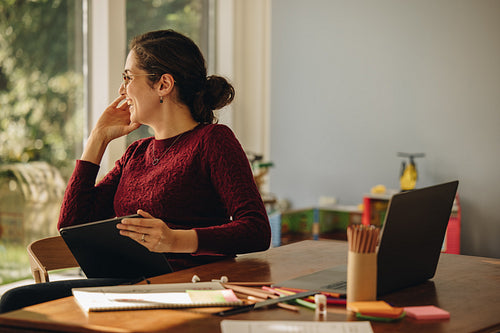 Smiling female illustration artist at home
