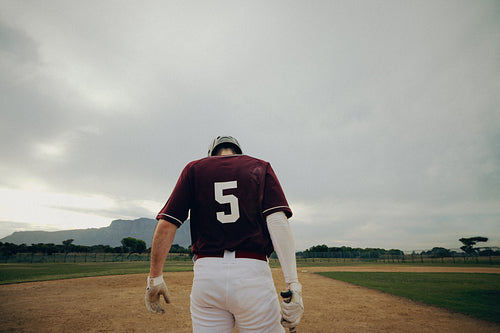Baseball player getting ready for game day, poised to start with determination and focus