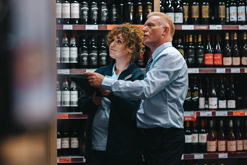 Sommeliers taking inventory in liquor store