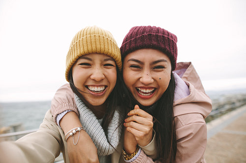 Close up of two asian women standing together outdoors