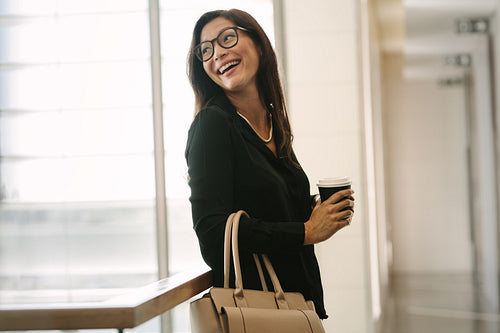 Female executive standing in office during break