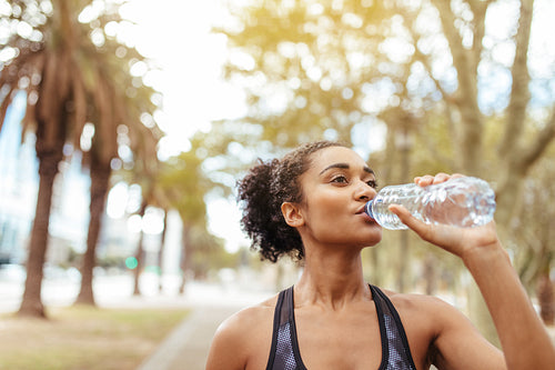 Athlete drinking water during morning jog