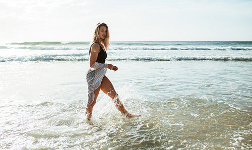 Woman walking in water at the beach