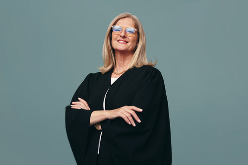 Cheerful female judge smiling at the camera in a studio