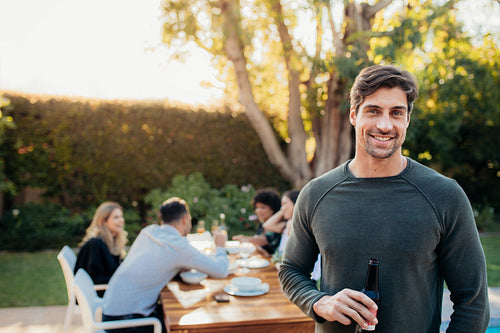Man with beer at outdoor party