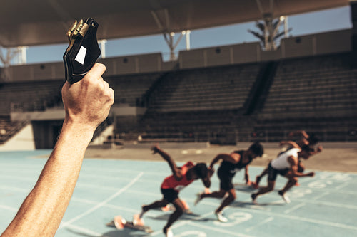 Athletes running a race in a track and field stadium
