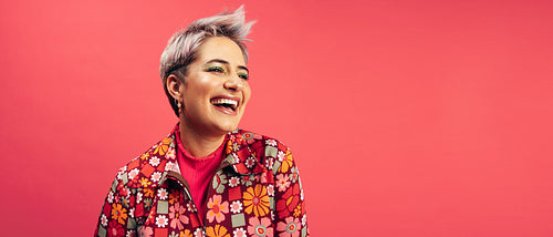 Cheerful hipster woman smiling in a studio