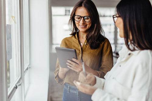 Business women standing in an office and discussing their ideas