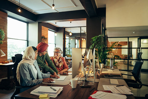 Cheerful businesswomen working together in a coworking office