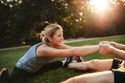 Young health couple exercising in park