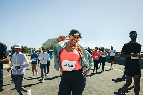 Joyful multiracial female athlete running in a race event