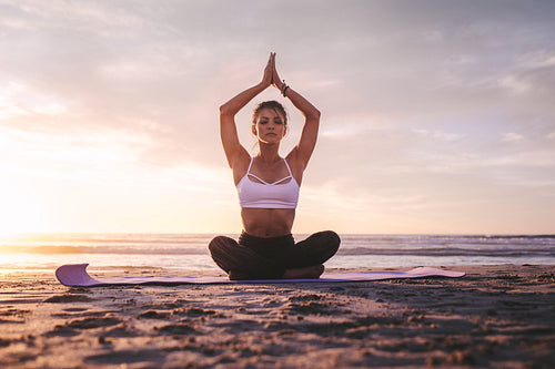 Woman in meditation on the beach