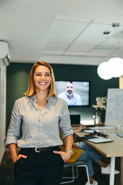 Cheerful business manager standing in a boardroom