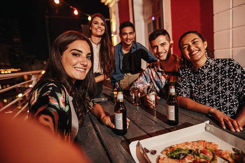 Young people taking self portrait at party