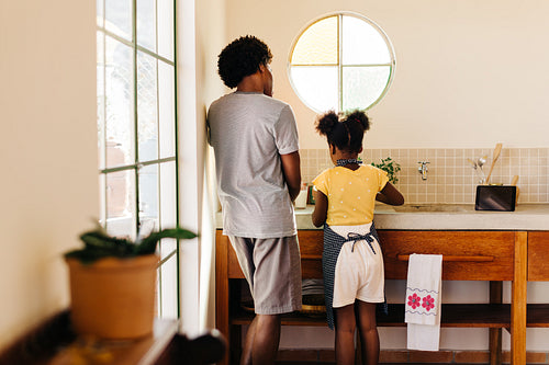 Two siblings baking making kitchen memories together at home
