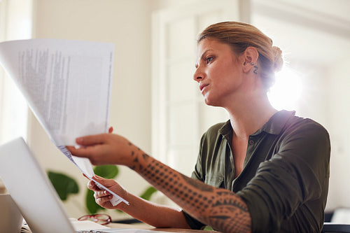 Woman  going through some paperwork at home