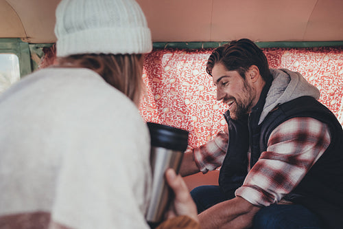 Friends on roadtrip sitting inside the van