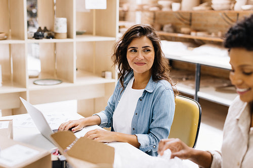 Happy online store owners preparing some orders for shipping