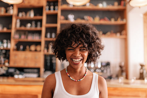 Happy young woman laughing in a cafe